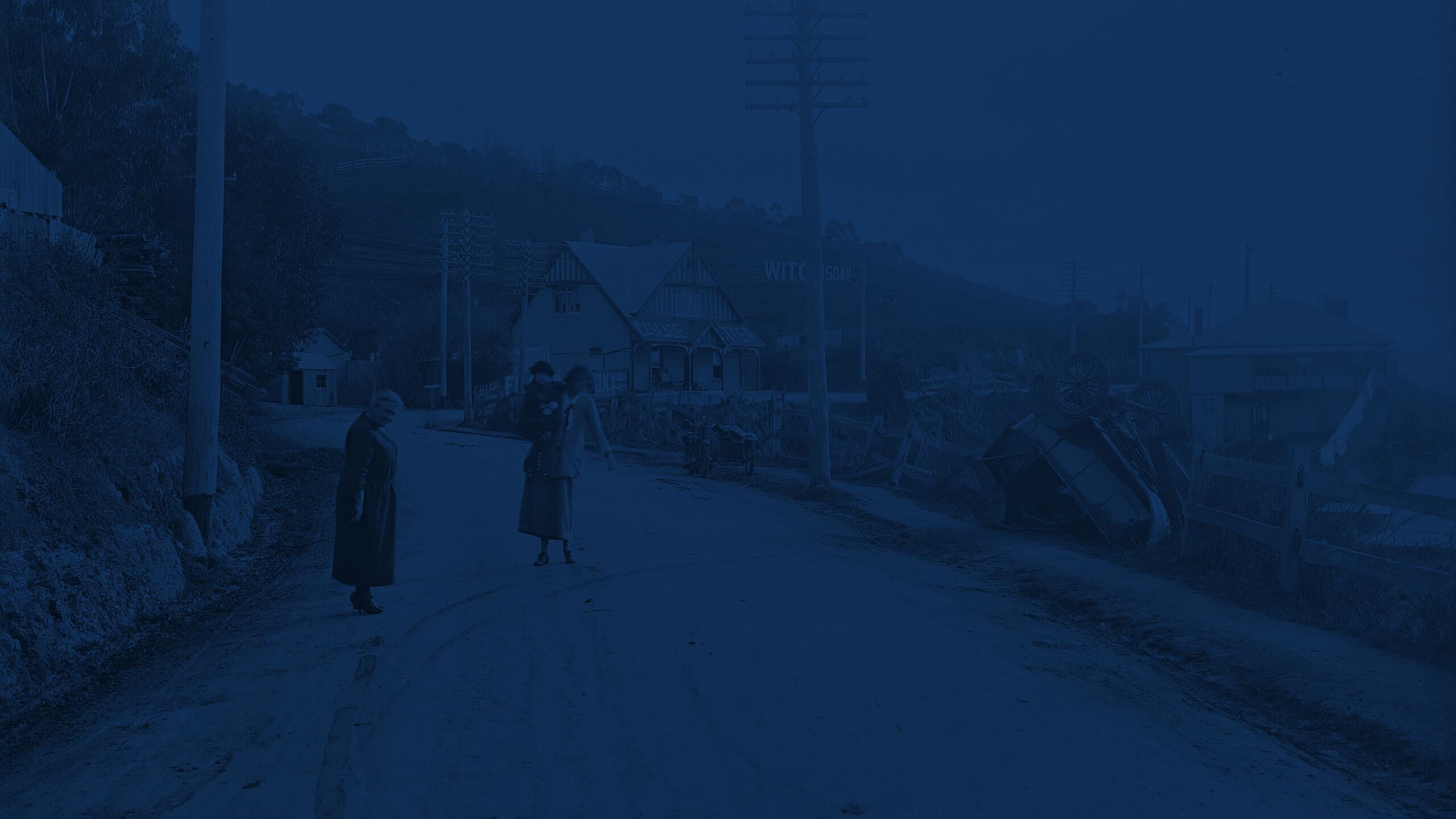 Vintage image with 2 people standing on a road