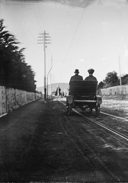 Vintage image of 2 people in a car from behind